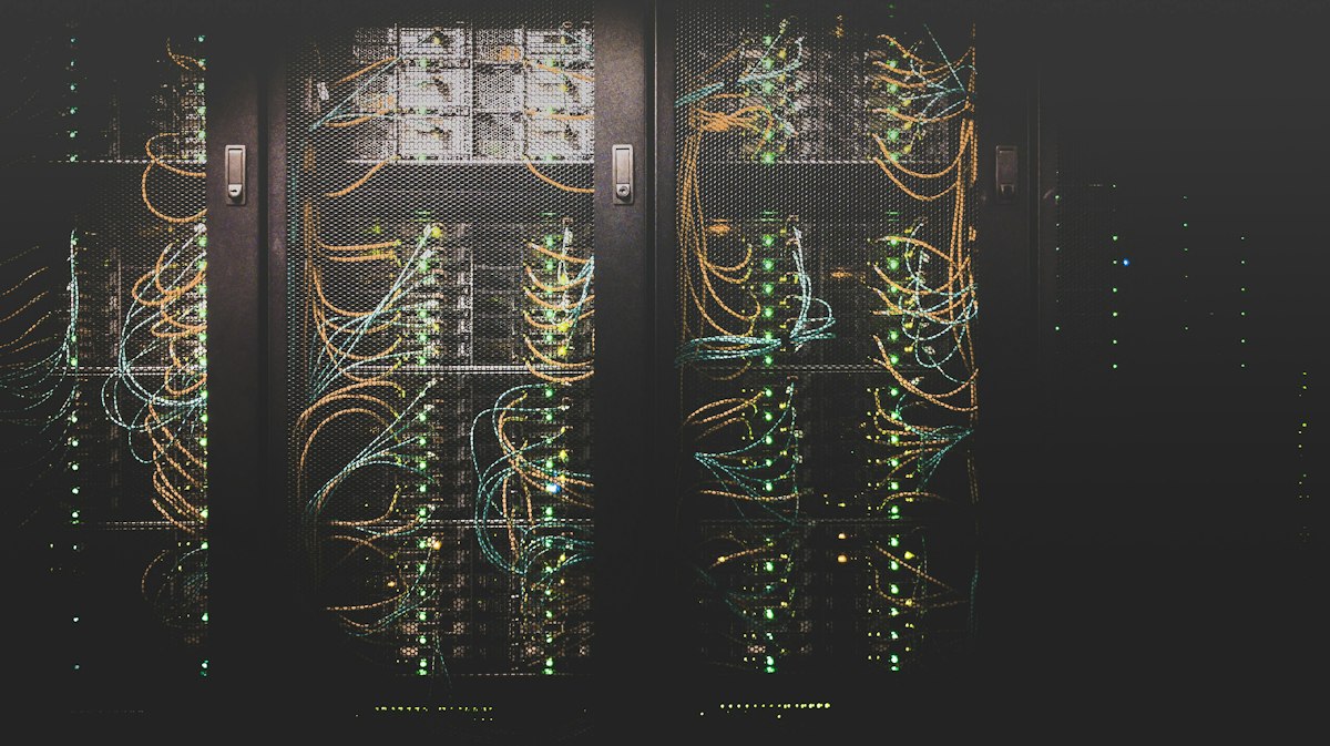 Racks of high-performance servers in an illuminated data center representing Crusoe AI infrastructure and energy computing