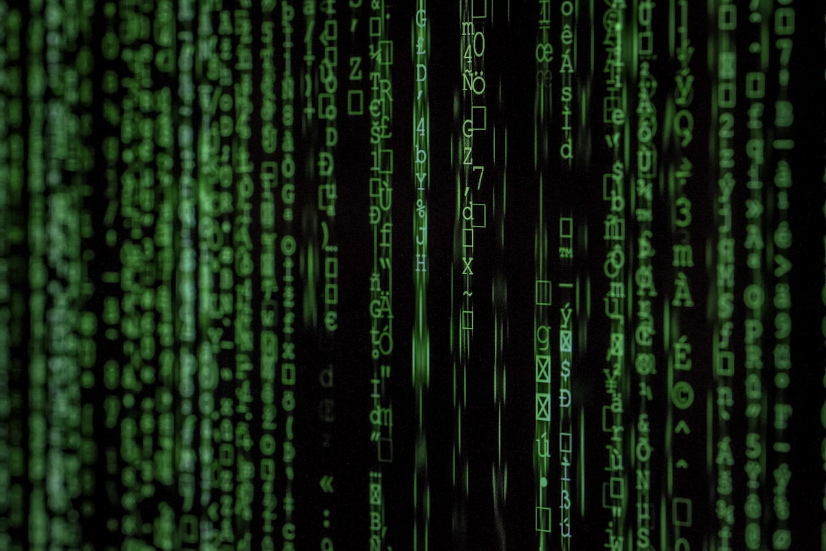 Digital green computer code streaming across a monitor depicting cybersecurity vulnerabilities and AI data hacks