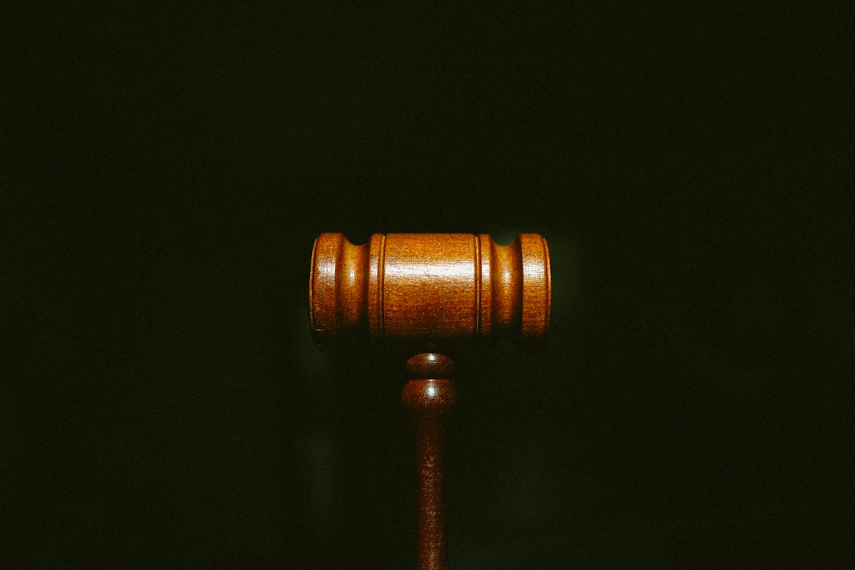 Grok AI Lawsuit Courtroom Gavel Wooden judge gavel resting on a sound block symbolizing legal action and lawsuit proceedings against Grok AI